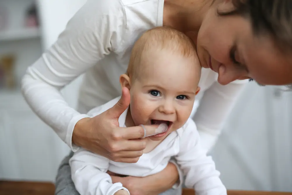 Image of baby getting teeth cleaned, important for children's dental health