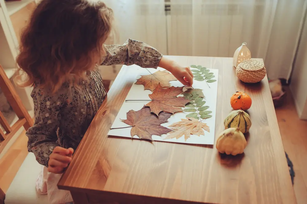 Image of child painting leaves, easy kids crafts ideas